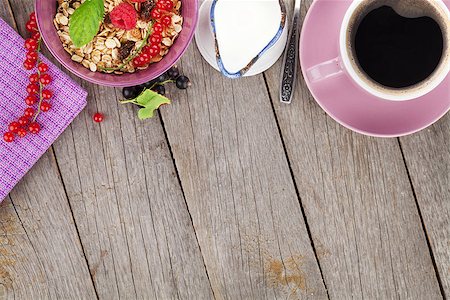 porridge and berries - Healthy breakfast with muesli and milk. View from above on wooden table with copy space Stock Photo - Budget Royalty-Free & Subscription, Code: 400-07894892
