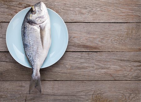 fresh blue fish - Fresh dorado fish on wooden table with copy space Stock Photo - Budget Royalty-Free & Subscription, Code: 400-07894934
