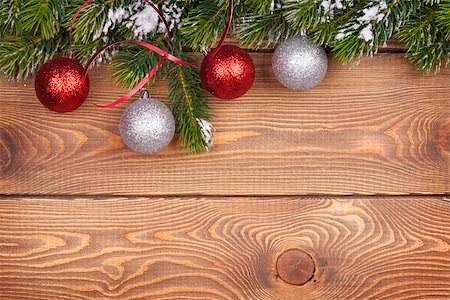 Christmas fir tree with snow and baubles on rustic wooden board with copy space Stock Photo - Budget Royalty-Free & Subscription, Code: 400-07894961