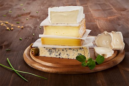 emmentaler cheese - Various cheese sorts on wooden board with olives, wheat and chive. Stock Photo - Budget Royalty-Free & Subscription, Code: 400-07895341