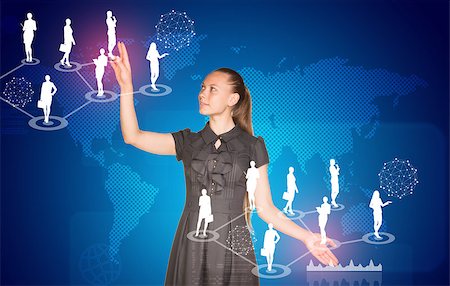 simsearch:400-07895693,k - Beautiful businesswoman in dress presses virtual button. World map and business silhouettes in background Stock Photo - Budget Royalty-Free & Subscription, Code: 400-07895691