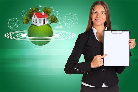 simsearch:400-07895693,k - Beautiful businesswoman in suit holding paper holder. Earth with house and trees in background Stock Photo - Budget Royalty-Free & Subscription, Code: 400-07895711