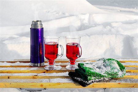 Thermos bottle, two glasses of mulled wine and mittens on a snow-covered bench on a snowy background Stock Photo - Budget Royalty-Free & Subscription, Code: 400-07895741