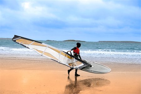 lone windsurfer getting ready to surf on the beach in the maharees county kerry ireland Foto de stock - Royalty-Free Super Valor e Assinatura, Número: 400-07896305