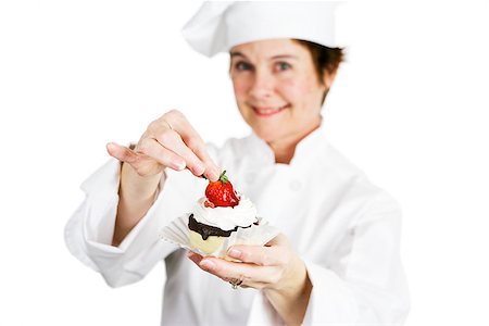 pastry chef uniform for women - Closeup of a pretty baker holding a delicious strawberry chocolate cheesecake tart.  Shallow depth of field with focus on the strawberry and the tart. Stock Photo - Budget Royalty-Free & Subscription, Code: 400-07896342