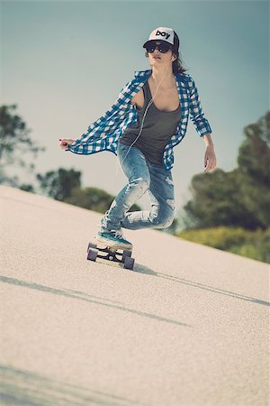 Young woman down the road with a skateboard Stock Photo - Budget Royalty-Free & Subscription, Code: 400-07896615