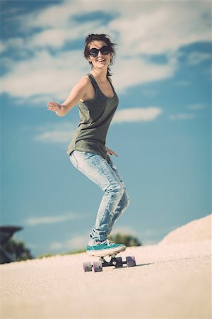 Young woman down the road with a skateboard Stock Photo - Budget Royalty-Free & Subscription, Code: 400-07896612