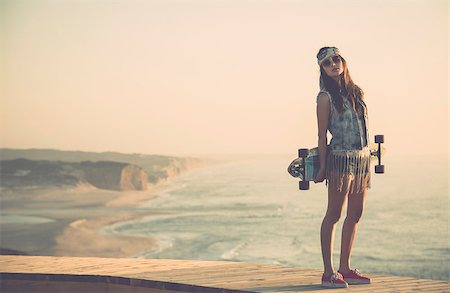 Beautiful and fashion young woman posing with a skateboard Stock Photo - Budget Royalty-Free & Subscription, Code: 400-07896628