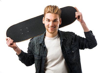 Studio portrait of a young man posing with a skateboard Stock Photo - Budget Royalty-Free & Subscription, Code: 400-07896665