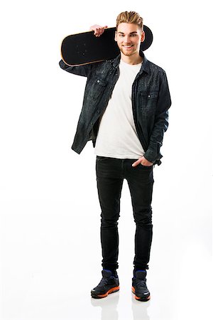 Studio portrait of a young man posing with a skateboard Stock Photo - Budget Royalty-Free & Subscription, Code: 400-07896669