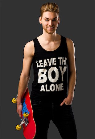 Studio portrait of a young man posing with a skateboard Stock Photo - Budget Royalty-Free & Subscription, Code: 400-07896678