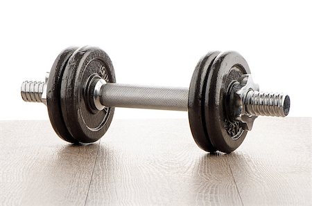 Fitness exercise equipment dumbbell weights on wood background. Foto de stock - Super Valor sin royalties y Suscripción, Código: 400-07897316