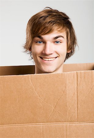 Portrait of a handsome young man inside a cardbox Stock Photo - Budget Royalty-Free & Subscription, Code: 400-07897648