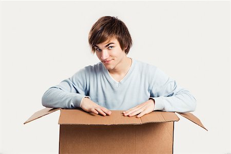 Portrait of a handsome young man inside a cardbox Stock Photo - Budget Royalty-Free & Subscription, Code: 400-07897649