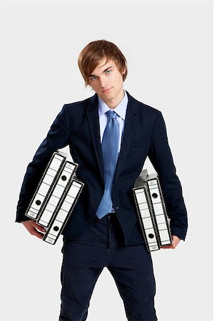 simsearch:400-04255357,k - Young business man carrying a bunch of folders Stock Photo - Budget Royalty-Free & Subscription, Code: 400-07897657
