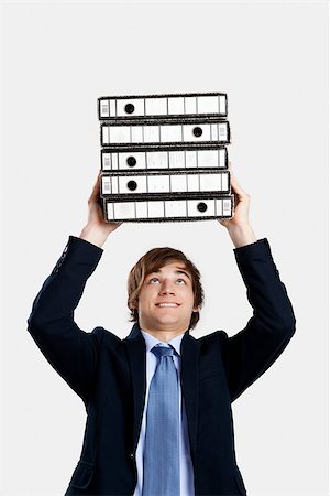 simsearch:400-04255357,k - Young business man carrying a bunch of folders Stock Photo - Budget Royalty-Free & Subscription, Code: 400-07897659