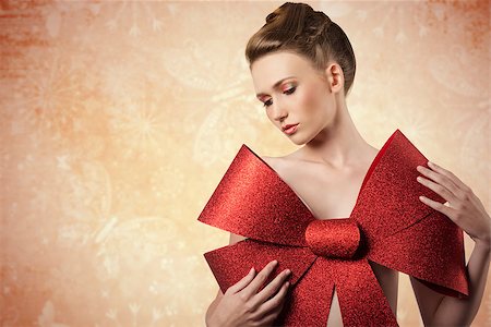 simsearch:400-07218439,k - christmas shoot of sensual young girl adorned like a present  with elegant hair-style, colorful make-up and big red glitter bow on her beast, Foto de stock - Super Valor sin royalties y Suscripción, Código: 400-07897897