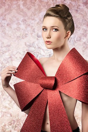 simsearch:400-07218439,k - sensual woman with elegant blonde hair-style posing in christmas shoot with big red glitter bow covering her naked breast, looking in camera Foto de stock - Super Valor sin royalties y Suscripción, Código: 400-07897899