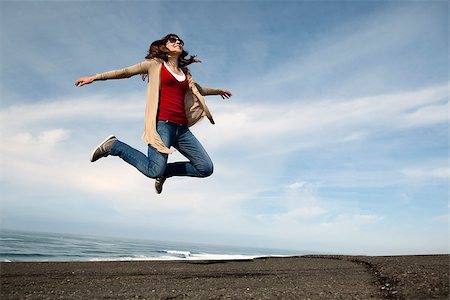 Woman jumping against a blue sky Stock Photo - Budget Royalty-Free & Subscription, Code: 400-07898728