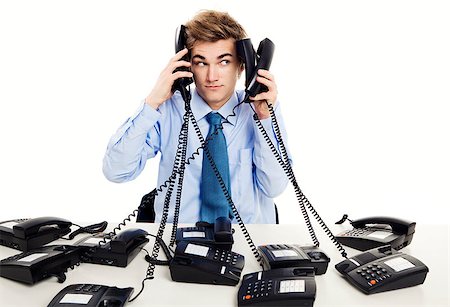 simsearch:400-05710310,k - Young man in the office and answering several phones at the same time Stock Photo - Budget Royalty-Free & Subscription, Code: 400-07898755