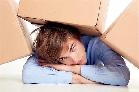 Exhausted young man with card boxes over him Stock Photo - Budget Royalty-Free & Subscription, Code: 400-07898769