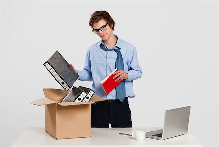 simsearch:400-08551867,k - Young man in the office packing up after being fired Stock Photo - Budget Royalty-Free & Subscription, Code: 400-07898777