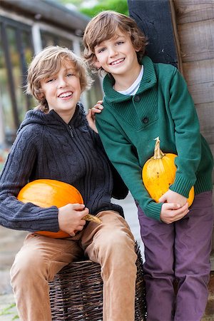 Two young happy smiling boys brothers outside with pumpkins Stock Photo - Budget Royalty-Free & Subscription, Code: 400-07899160