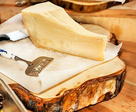 Parmesan cheese on a wooden plate Stock Photo - Budget Royalty-Free & Subscription, Code: 400-07899379