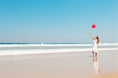 photo girl walking with balloon - Beautiful girl walking in the beach with red ballons in her hand Stock Photo - Budget Royalty-Free & Subscription, Code: 400-07899682
