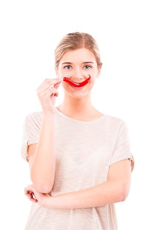 simsearch:400-04575822,k - Beautiful girl making a smile with a red chilli pepper in front of the mouth, isolated over white background Photographie de stock - Aubaine LD & Abonnement, Code: 400-07899694