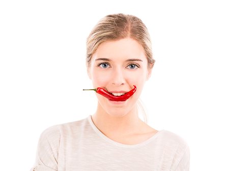 simsearch:400-04575822,k - Beautiful girl biting a red chilli pepper, isolated over a white background Photographie de stock - Aubaine LD & Abonnement, Code: 400-07899700