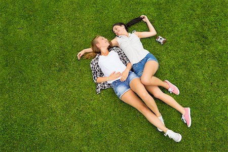 Female best Friends lying on the grass and having a good time together Stock Photo - Budget Royalty-Free & Subscription, Code: 400-07899745
