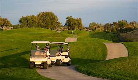 Two golf carts stand on the path beside the ninth hole Stock Photo - Budget Royalty-Free & Subscription, Code: 400-07891772