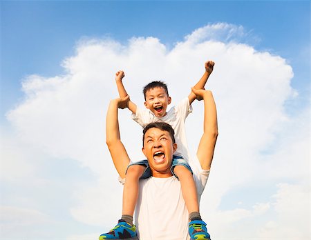 family relaxing with kids in the sun - happy little boy sitting on father's shoulder Stock Photo - Budget Royalty-Free & Subscription, Code: 400-07891826