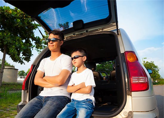 little boy and father sitting on their car in the park Stock Photo - Royalty-Free, Artist: tomwang, Image code: 400-07891828