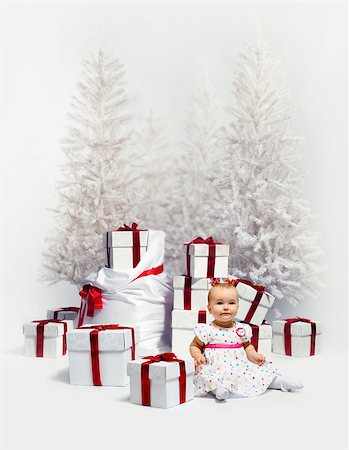 Adorable baby girl over christmas trees and heap of gift boxes background Stock Photo - Budget Royalty-Free & Subscription, Code: 400-07891951