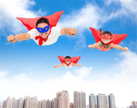 super strong girl - superman and daughters  flying in the sky with buildings background Stock Photo - Budget Royalty-Free & Subscription, Code: 400-07892092