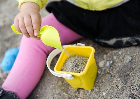 Lovely baby girl playing with plastic shovel and basket Stock Photo - Budget Royalty-Free & Subscription, Code: 400-07892161