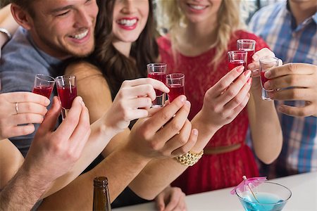 drinking shots - Happy friends having a drink together at the bar Stock Photo - Budget Royalty-Free & Subscription, Code: 400-07900651