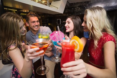 simsearch:649-06844392,k - Happy friends having a drink together at the bar Stock Photo - Budget Royalty-Free & Subscription, Code: 400-07900697