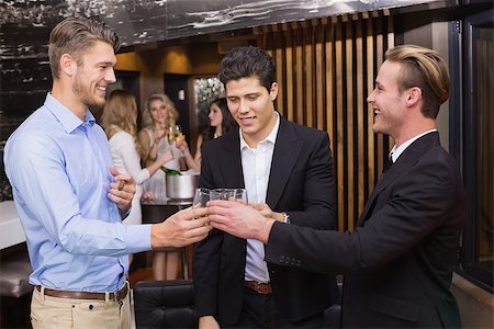 people laughing in pub - Handsome friends having a drink together at the bar Stock Photo - Budget Royalty-Free & Subscription, Code: 400-07900766