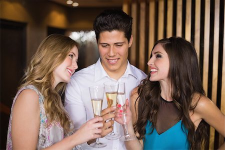 people laughing in pub - Attractive friends toasting with champagne at the bar Stock Photo - Budget Royalty-Free & Subscription, Code: 400-07900789