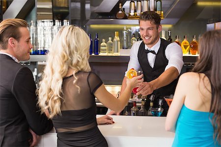 simsearch:649-06844392,k - Attractive friends being served cocktails at the bar Stock Photo - Budget Royalty-Free & Subscription, Code: 400-07900814