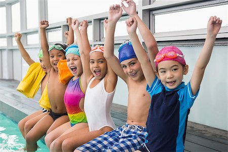 Cute swimming class smiling poolside at the leisure center Stock Photo - Budget Royalty-Free & Subscription, Code: 400-07900929