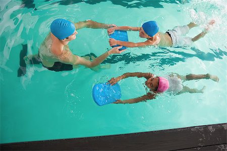 simsearch:640-02951323,k - Cute swimming class in pool with coach at the leisure center Stockbilder - Microstock & Abonnement, Bildnummer: 400-07901085