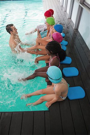 simsearch:640-06963379,k - Cute swimming class in pool with coach at the leisure center Photographie de stock - Aubaine LD & Abonnement, Code: 400-07901089