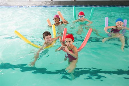 simsearch:400-05352235,k - Cute little kids in the swimming pool at the leisure center Photographie de stock - Aubaine LD & Abonnement, Code: 400-07901120