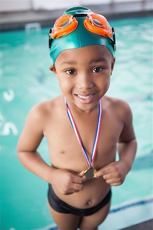 swimmer medal - Cute little boy with his medal at the pool at the leisure center Stock Photo - Budget Royalty-Free & Subscription, Code: 400-07901143