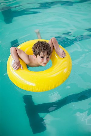 Little boy swimming with rubber ring at the leisure center Stock Photo - Budget Royalty-Free & Subscription, Code: 400-07901174