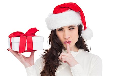 simsearch:400-07902186,k - Festive brunette holding gift and keeping a secret on white background Foto de stock - Super Valor sin royalties y Suscripción, Código: 400-07901598